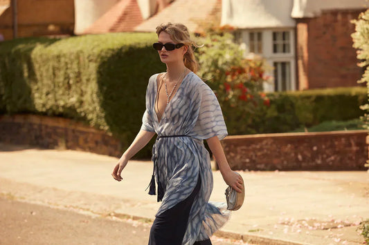 Woman wearing elegant blue kaftan on London street in summer