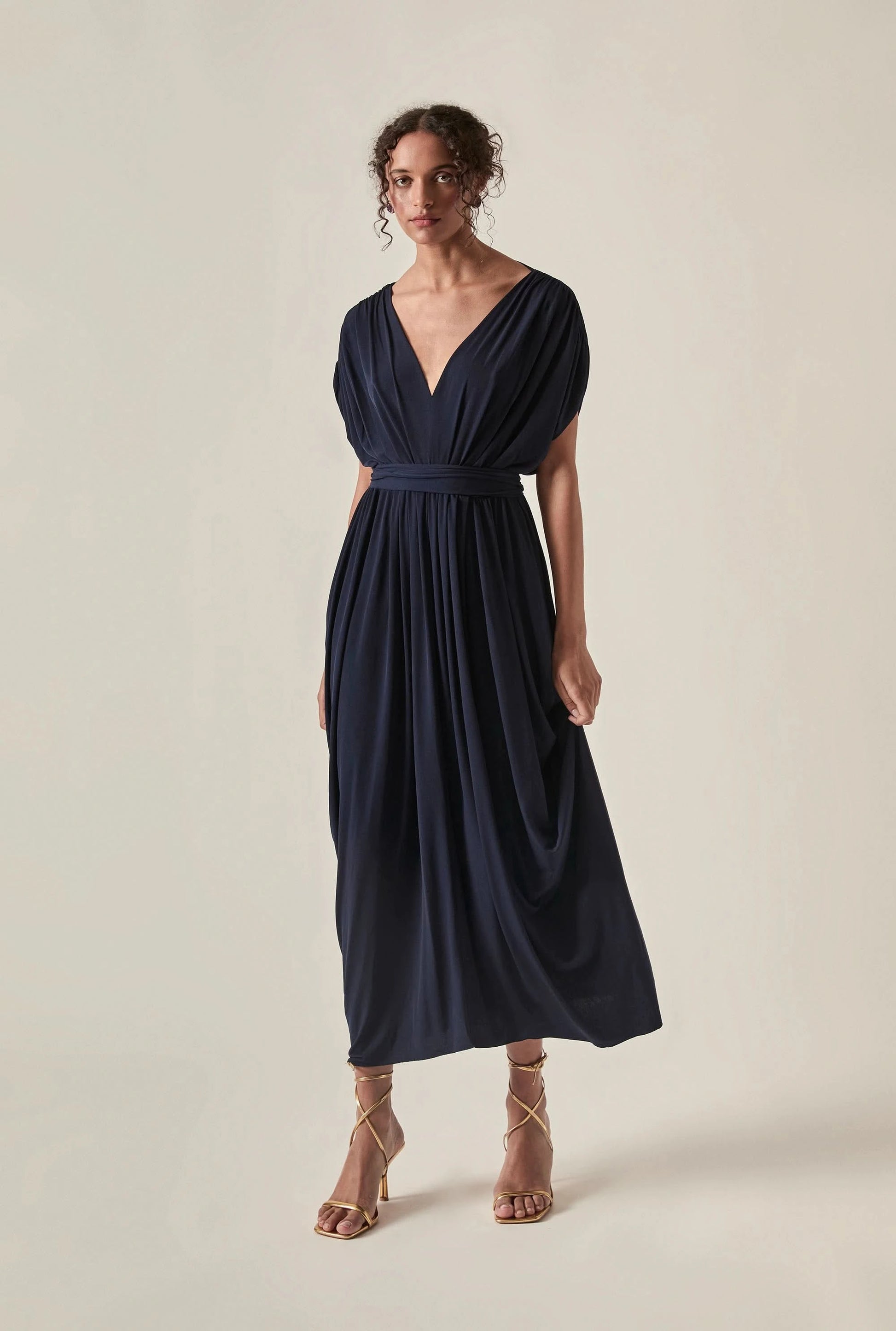 Front view of the Draped Open-Back Midi Dress in Navy by James Lakeland against a studio background
