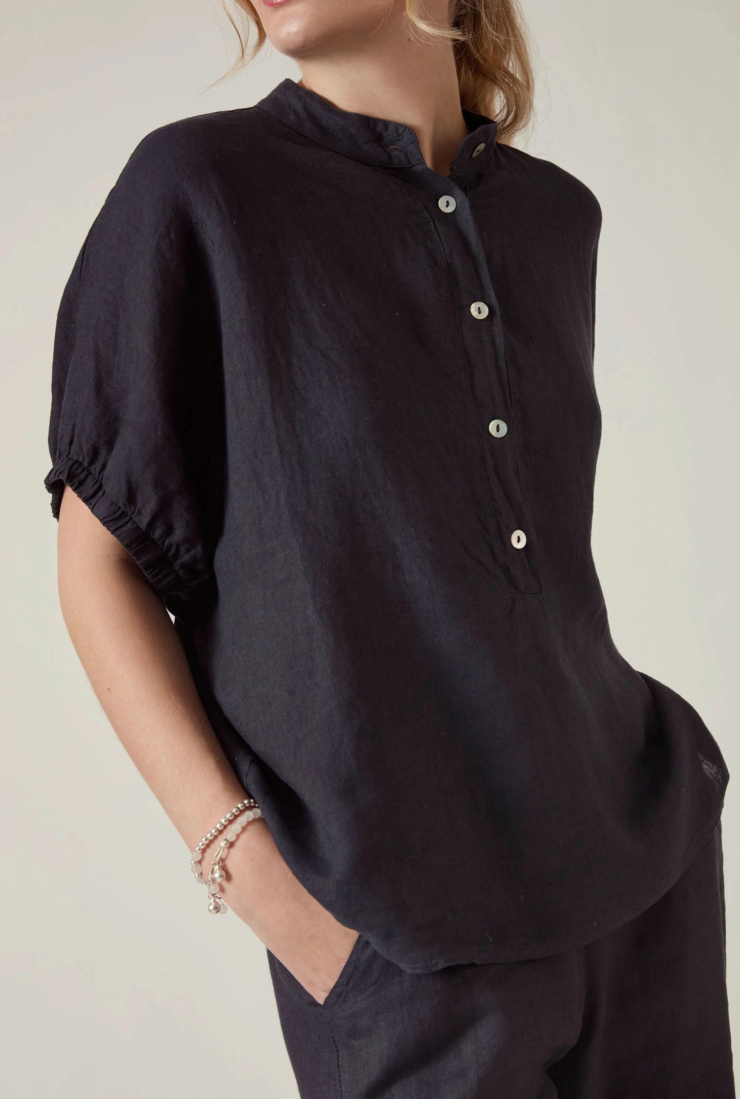 Close up detail of the linen fabric and puff sleeve on the James Lakeland navy blouse