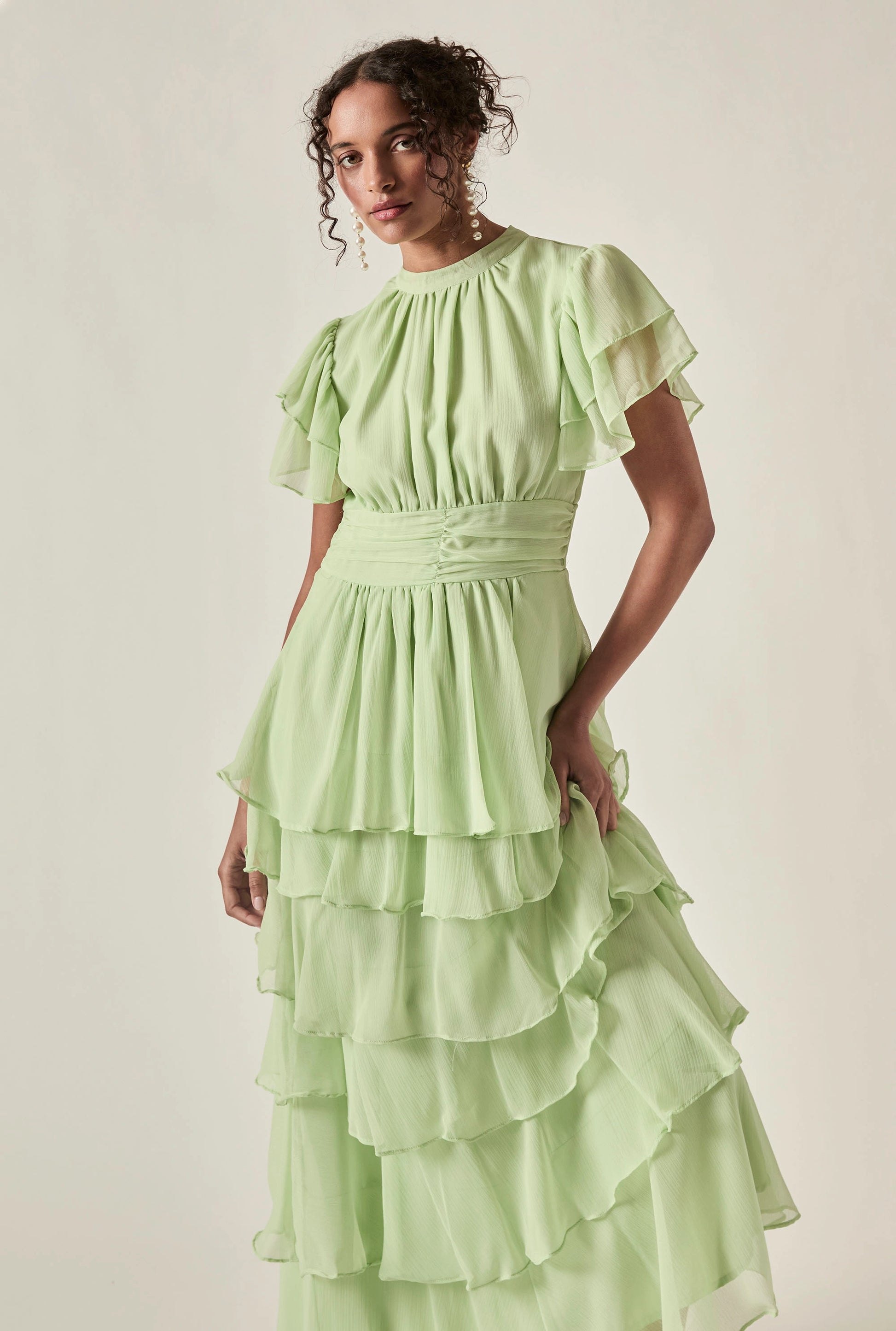 Model wearing Green Tiered Ruffle Maxi Dress – three-quarter view