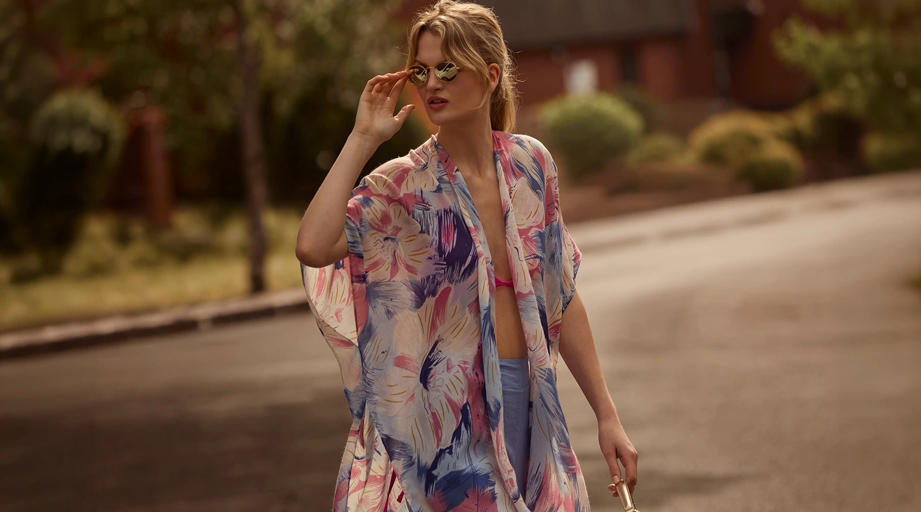 Woman wearing the Iris ombré kaftan by James Lakeland walking outdoors in the summer sunshine